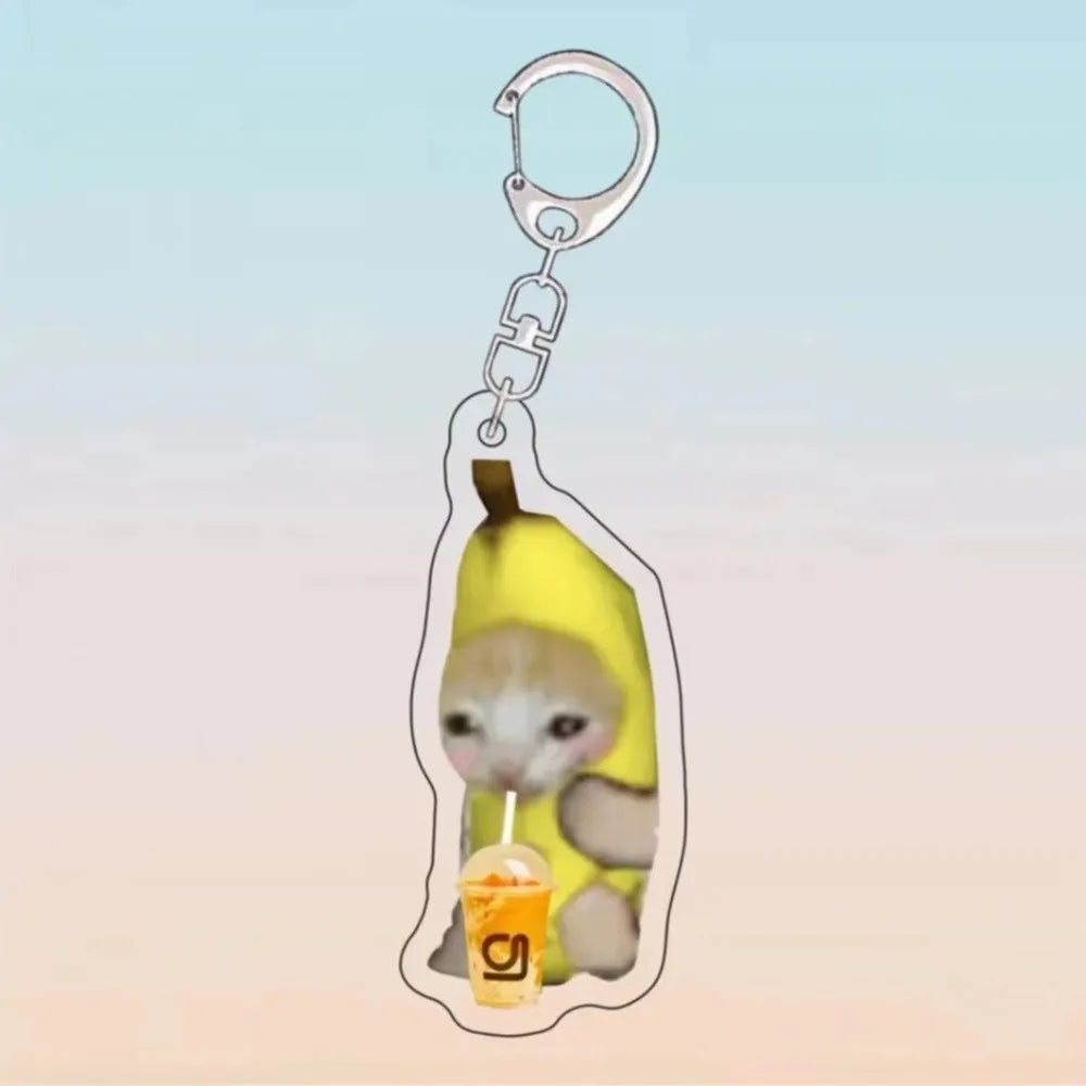 A yellow banana cat charm attached to a silver acrylic keychain ring.