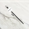 A black metal magic wand replica with a silver tip and a circular label marked Metal Core displayed on a white marble surface