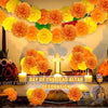 A decorative arrangement of artificial orange and yellow carnation and marigold flower heads for altar decoration.