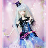 A light blue-haired doll in a black and blue outfit with sparkling effects against a pink background.