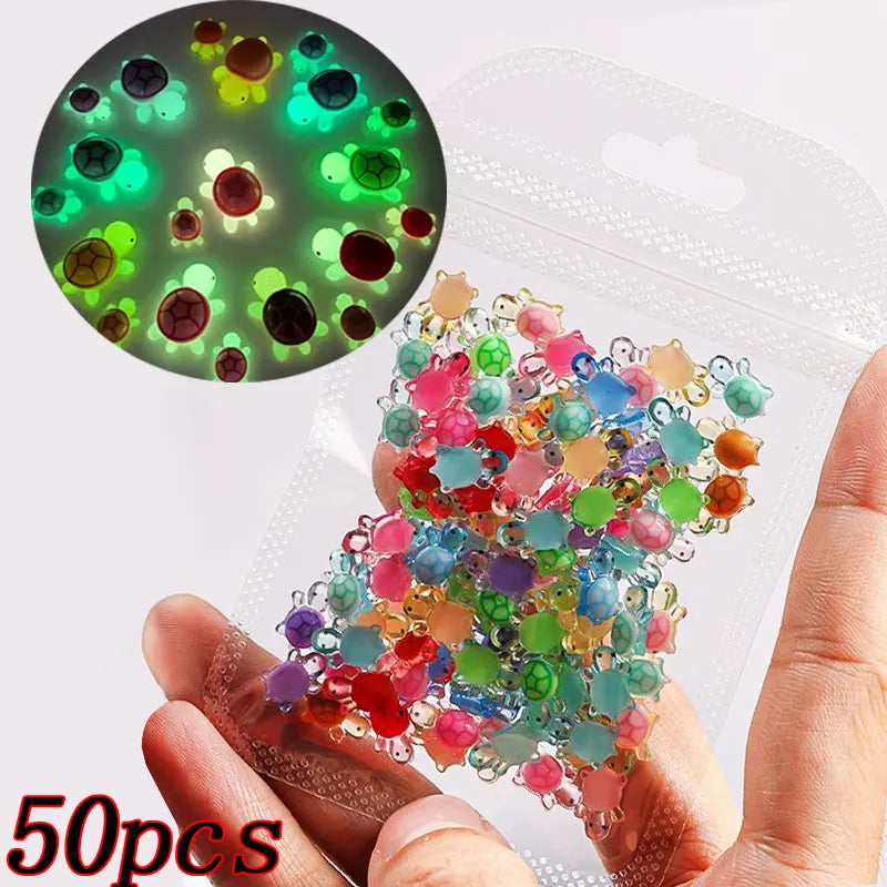 A hand holds a clear plastic bag filled with 50 colorful 3D resin ladybug nail art charms.