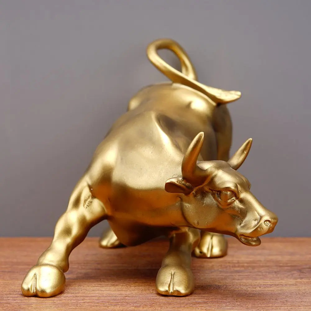 A golden sculpture of a bull head and body, designed for home decor.