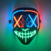 A glow-in-the-dark LED purge mask featuring glowing red and blue lines forming an 'X' pattern on a black face.