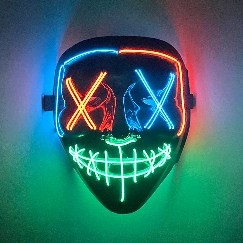 A glow-in-the-dark LED purge mask featuring glowing red and blue lines forming an 'X' pattern on a black face.