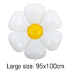 A cluster of white and yellow foil balloons shaped like daisies.