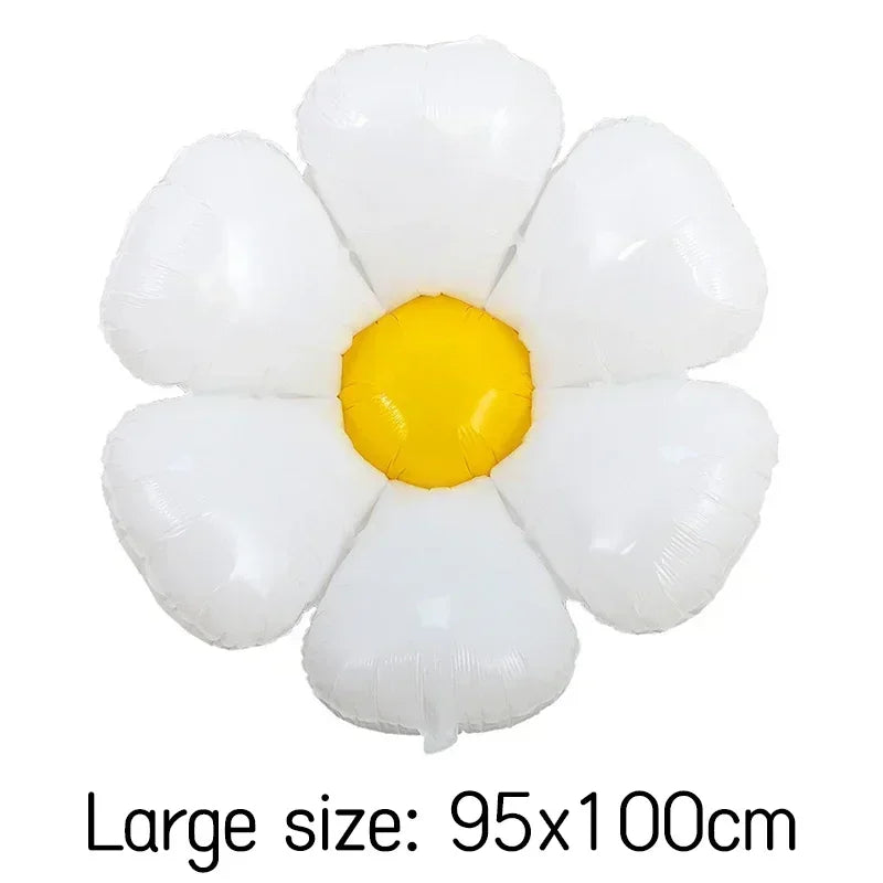 A cluster of white and yellow foil balloons shaped like daisies.