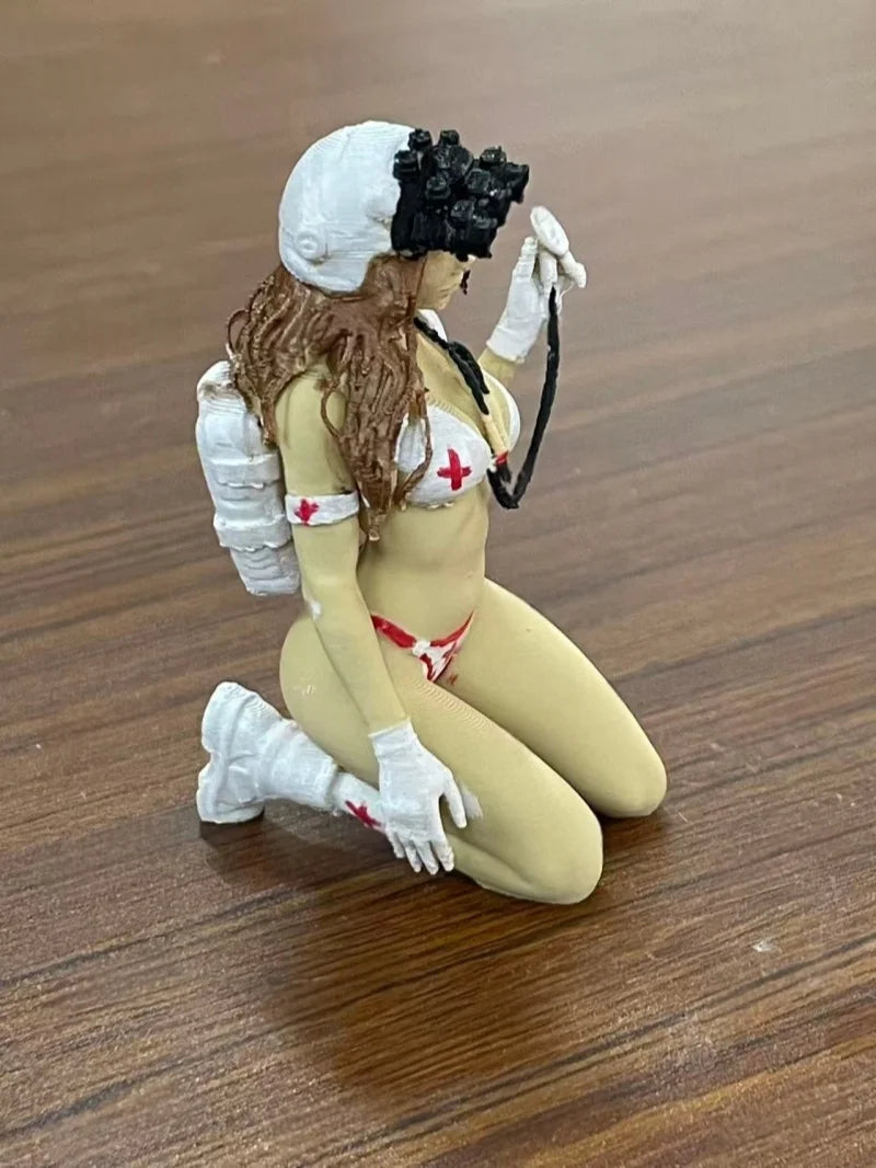 A female rifleman desktop figurine with long brown hair, wearing a white uniform and gloves, sitting on a wooden surface.