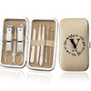 An open leather case displaying an 8-piece stainless steel manicure and pedicure kit with various tools.