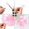 Hands demonstrate removing removable double-sided adhesive dots from a pink balloon for crafts.
