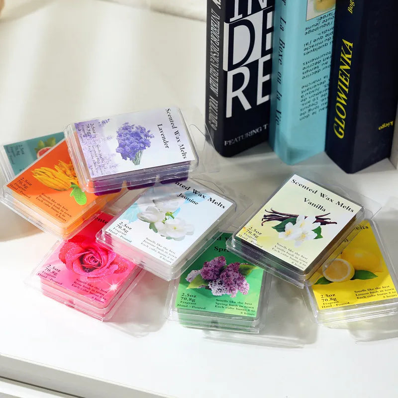A collection of hand-poured soy wax aromatherapy gift sets in various colors and scents displayed on a white surface.