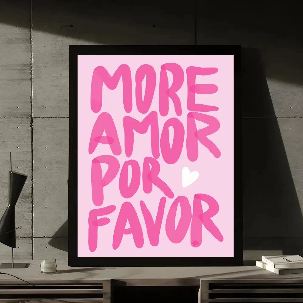 A framed print featuring the text MORE AMOR POR FAVOR in bright pink script on a light pink background.
