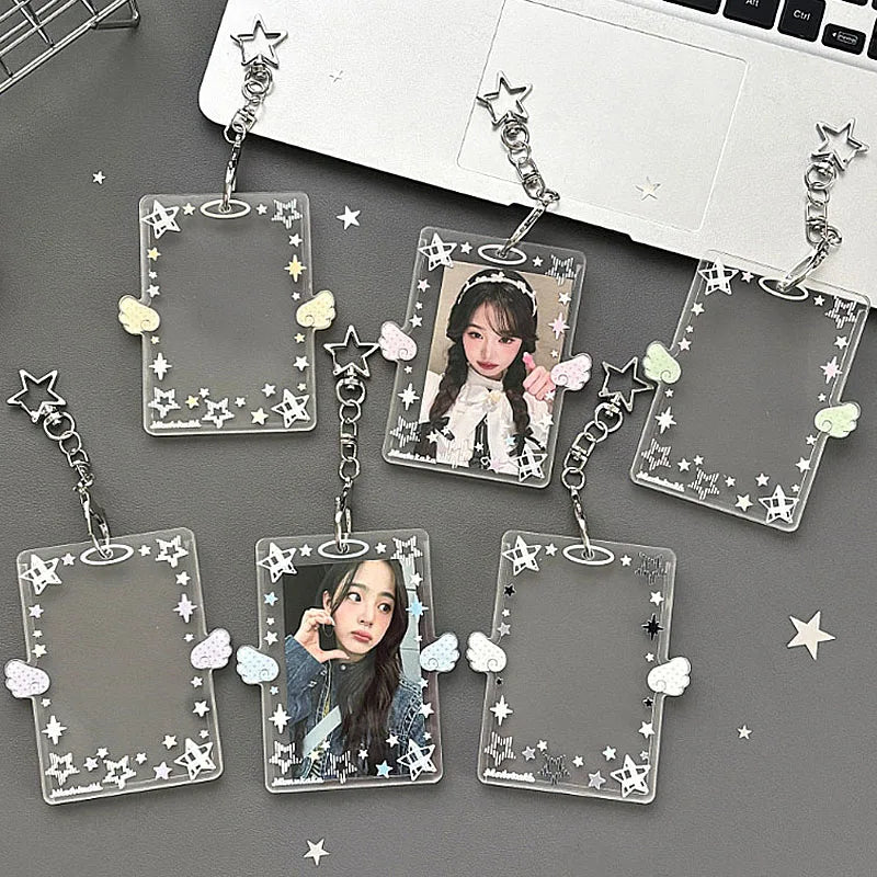 Multiple clear acrylic photo card holders with star charms and butterfly accents attached to silver keychains.