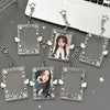 A collection of clear acrylic photo card holders with star charms and butterfly accents attached to silver keychains.
