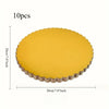 A set of ten round yellow disposable cake plates with a scalloped edge.