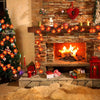 A fireplace decorated with a glowing orange LED string light garland and a Christmas tree.