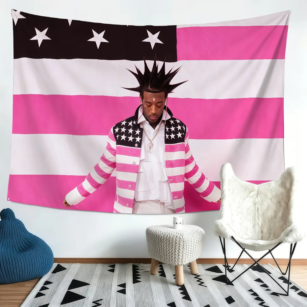 A person stands in front of a large pink and white American flag banner with stars, next to a white chair.