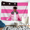 A person stands in front of a large pink and white American flag banner with stars, next to a white chair.