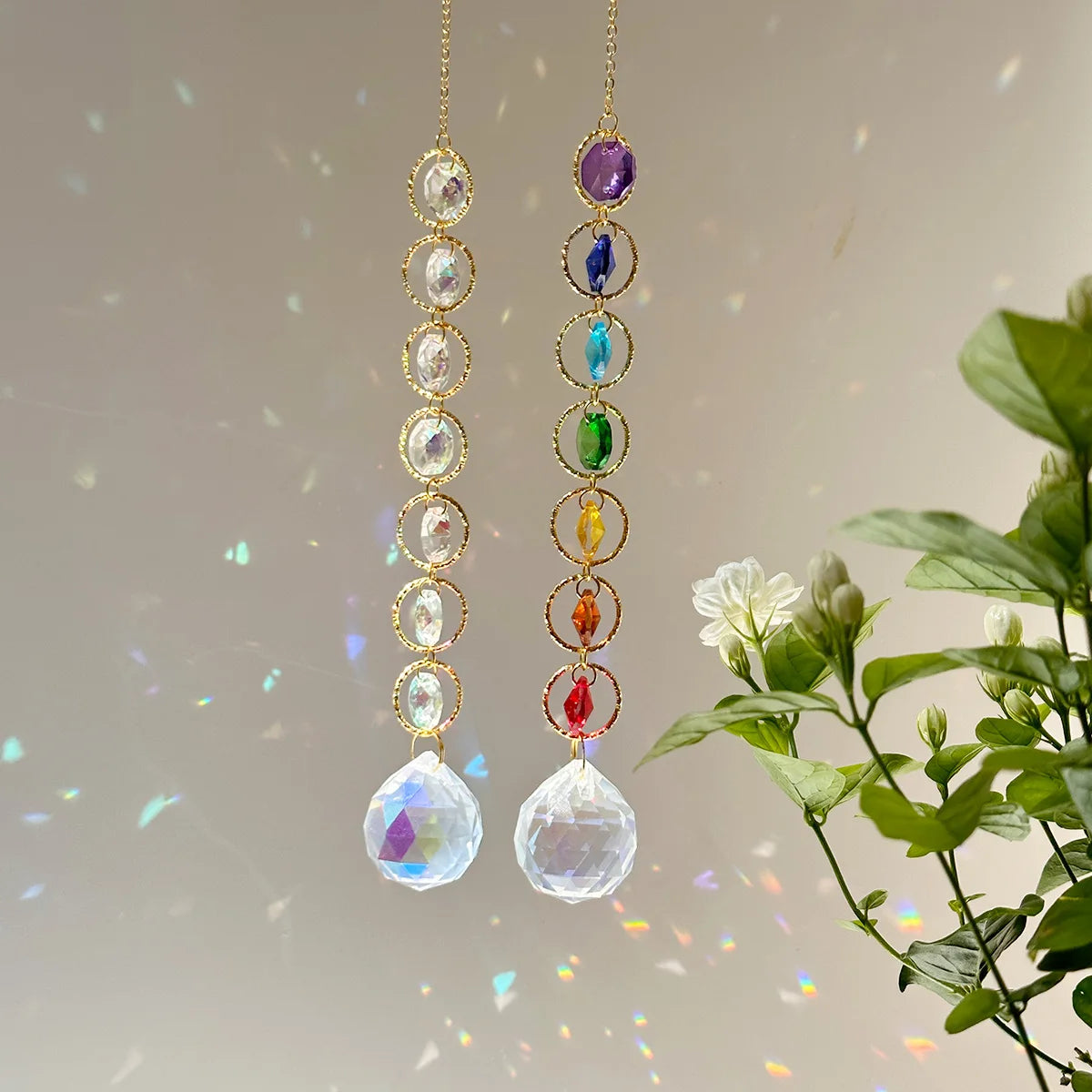 A pair of crystal prism suncatchers featuring strings of colorful beads and clear, faceted pendants.