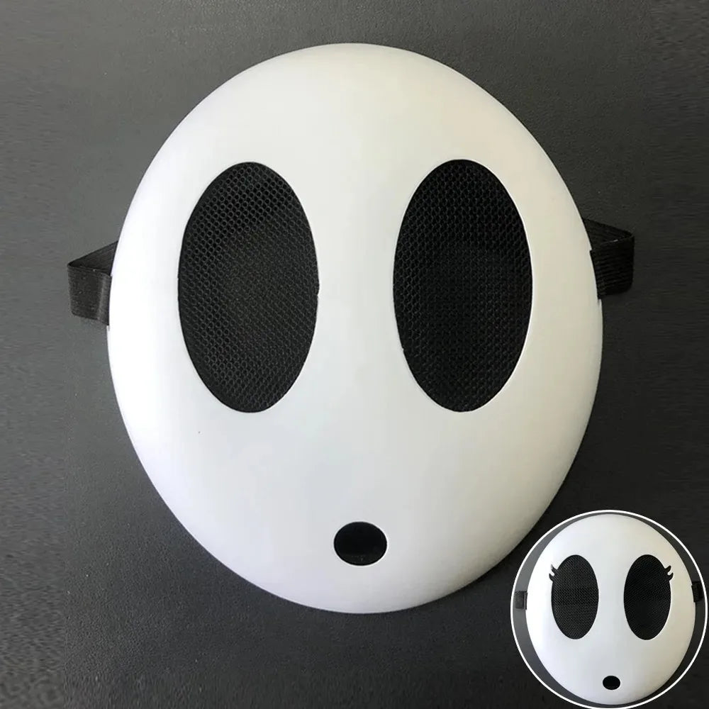 A white, round mask resembling a shy guy face with large black eye holes.