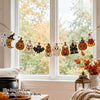 A vintage Halloween wooden hanging garland featuring retro pumpkin, ghost, and cat beads displayed in a bright window setting
