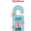 A light blue resin craft embellishment shaped like a key with the text Reading is progress and Do not disturb