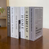 A row of nine hardcover books titled Create Pacific Natural At Home This Is Home Home Habitat and The Interior Design Handboo