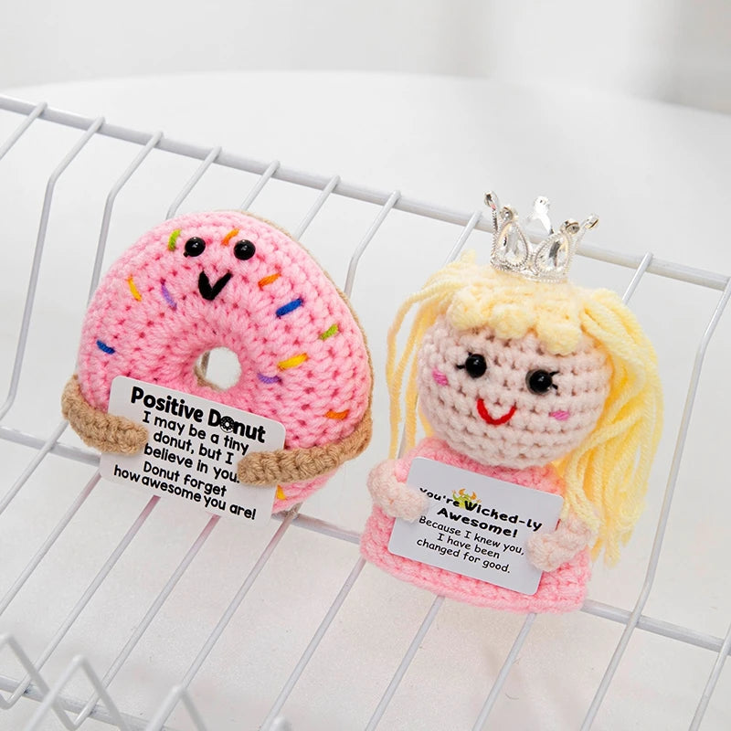 Handmade crochet positive donut doll with a sparkly crown and inspirational slogan