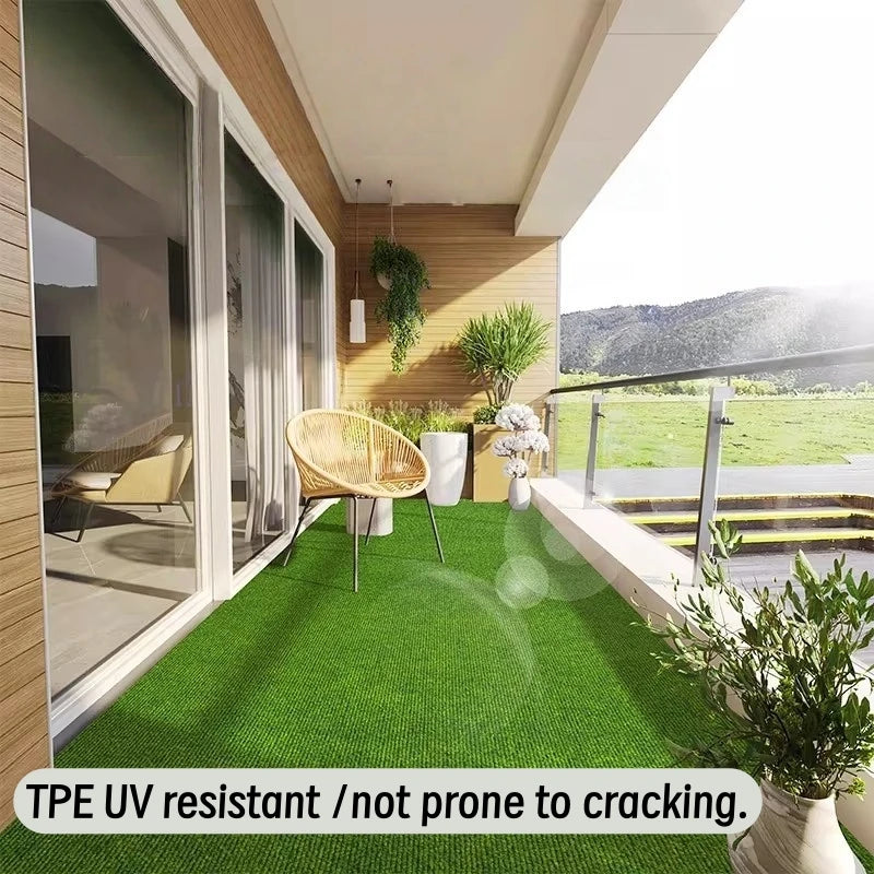 Artificial grass carpet installed on a balcony with modern glass railing and outdoor furniture.
