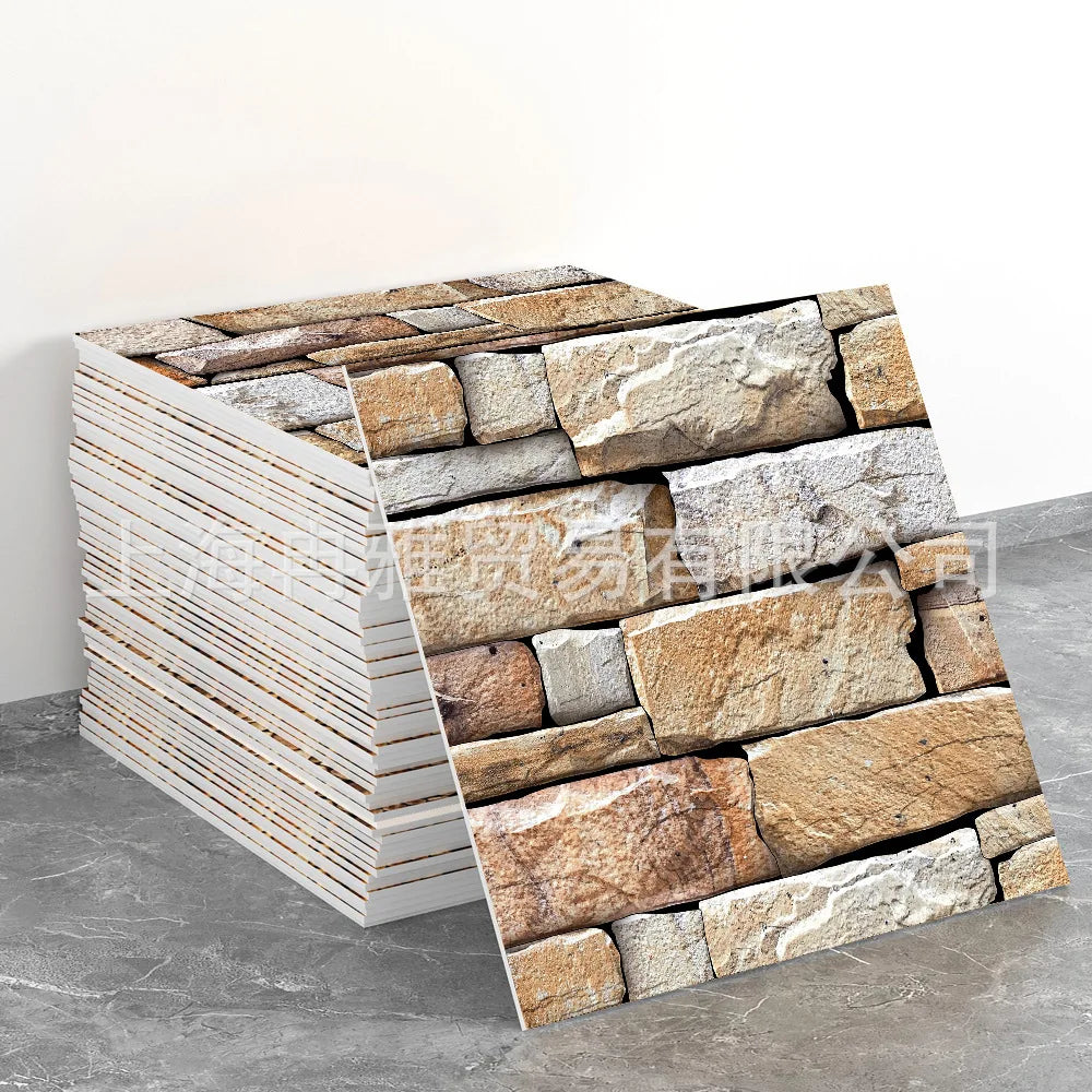 Stacked rectangular marble peel-and-stick tiles with gold accents displayed on a gray surface.