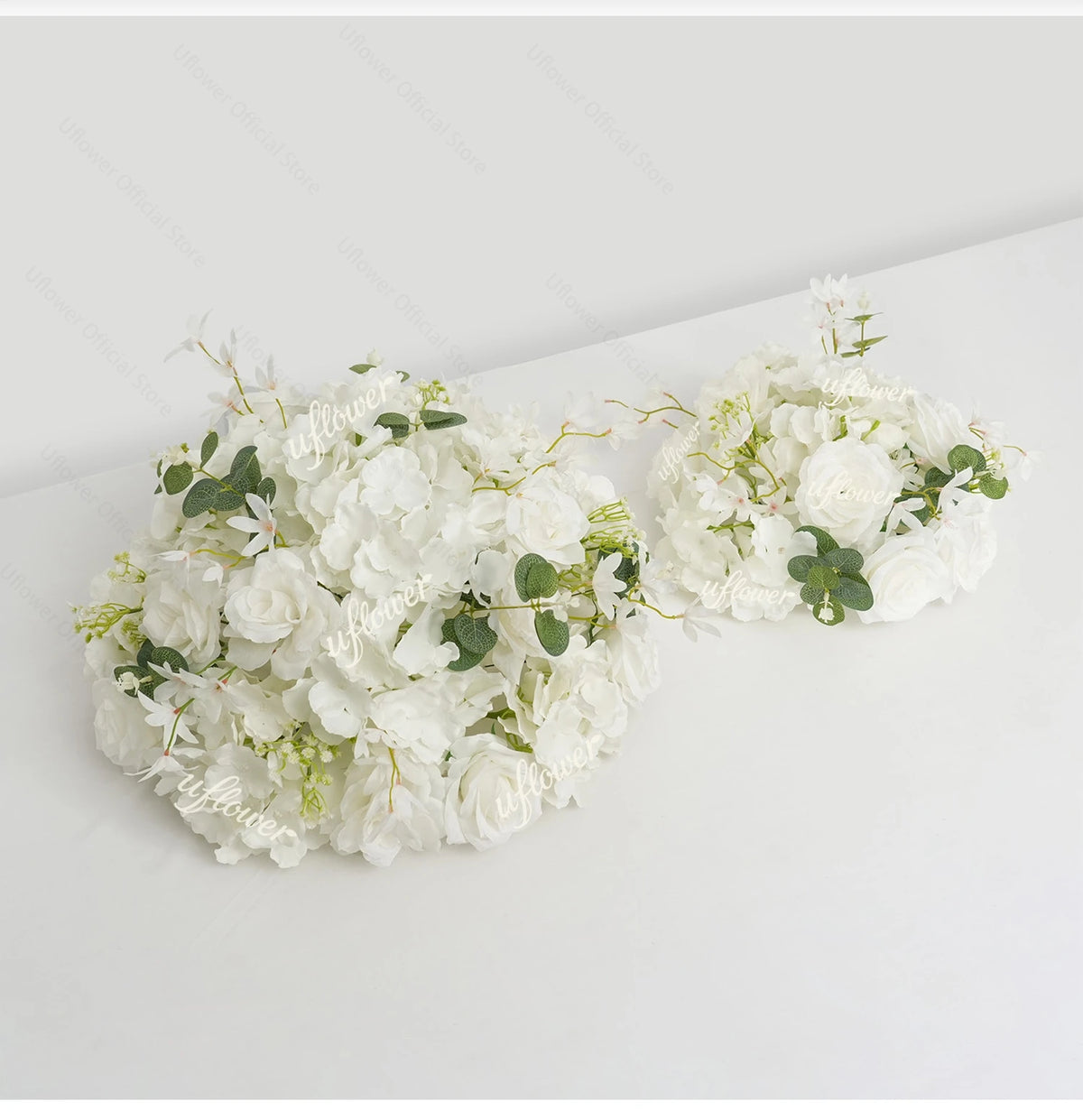 A white floral arrangement featuring roses and hydrangea flowers displayed as a centerpiece.