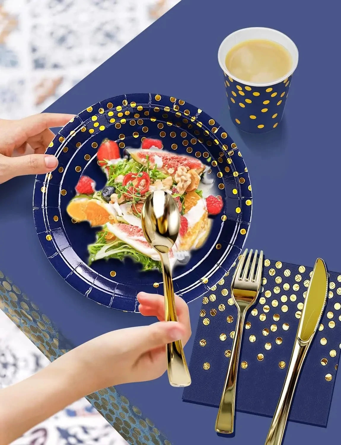 A hand is holding a gold spoon above a blue plate filled with fruit and salad, set against a dark blue background.