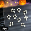A variety pack of 50 Halloween 3D resin nail charms featuring black and white cross shapes on a clear surface.