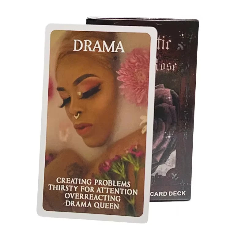 A tarot card titled Drama Queen from the Mystic Black Rose deck featuring a woman's face and pink flowers.