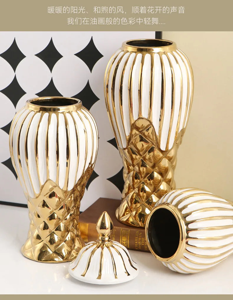 Two handcrafted ceramic decorative vases in gold and white stripes with a small lid.