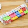 A plastic whistle set with various colored whistles packaged in a clear plastic bag on a wooden surface.