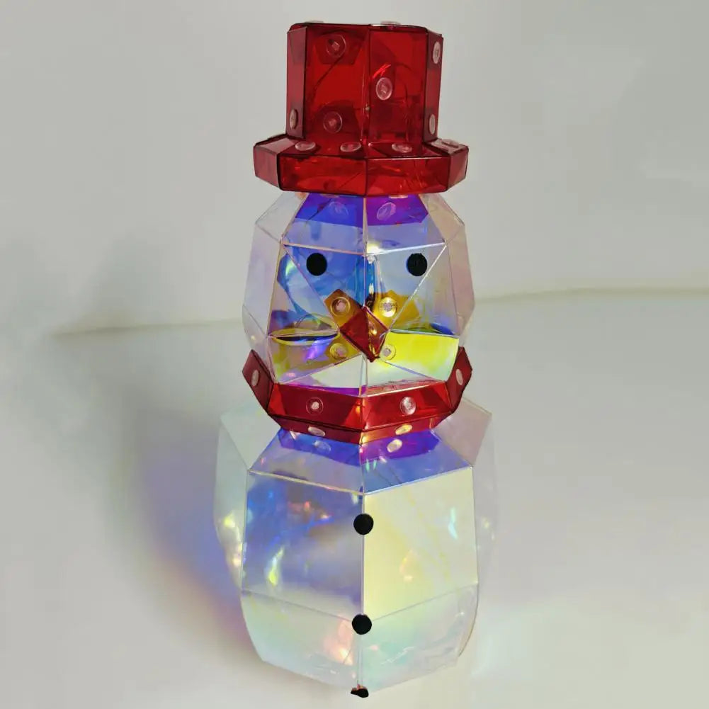 A prismatic LED snowman decoration with a red hat and body, illuminated from within.