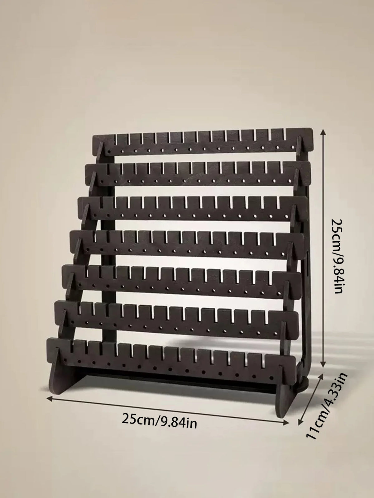 A black multilayer wooden earring organizer displaying jewelry on individual slots.