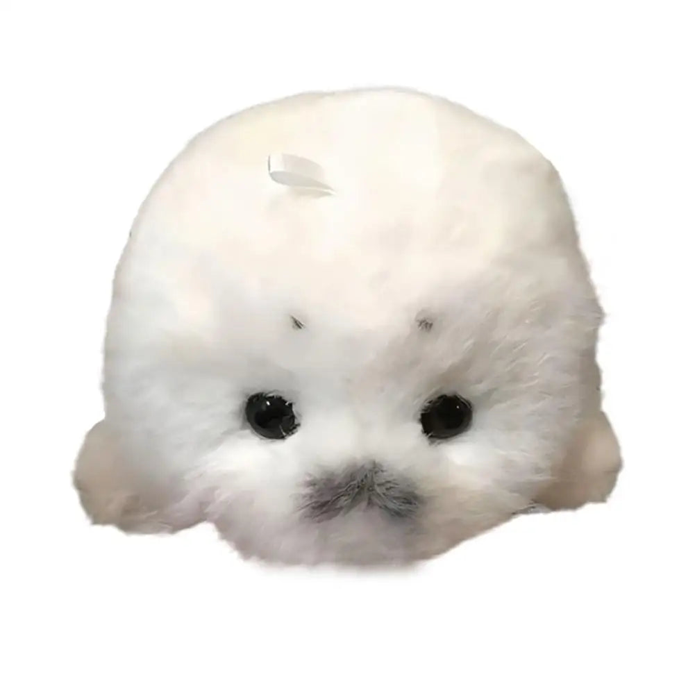 A small, white seal plush toy with a cute face and a tiny tag.