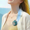 A young woman is smiling while wearing a portable, clip-on, bladeless cooling fan on her shirt.