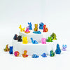 A collection of colorful mini animal figurines arranged on a white circular base.