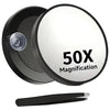 A black magnifying makeup mirror with a suction cup mount and a black handle.