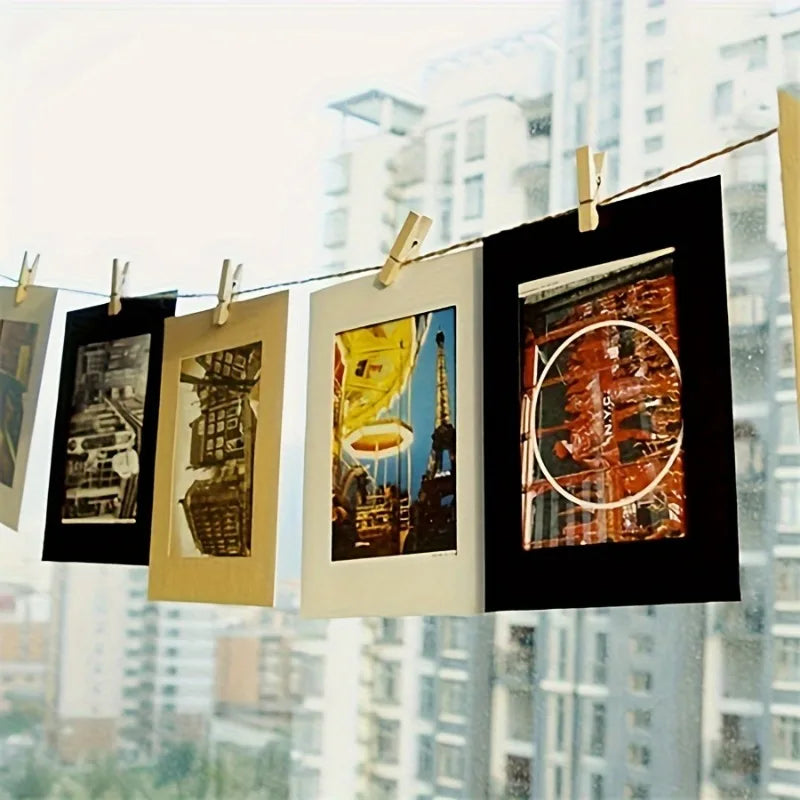 Vintage kraft paper photo frames hanging on a clothesline against a blurred city skyline