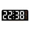 A black digital alarm clock displaying 22:38 with a mood light and day of the week indicator.