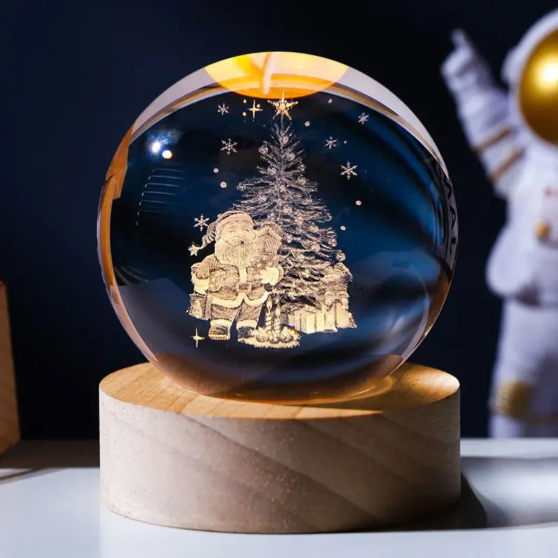 A dark blue crystal ball decoration featuring a laser engraved silhouette of a person standing next to a decorated Christmas 