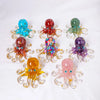 A collection of natural crystal octopus statues in various colors including blue, red, green, purple, and pink.