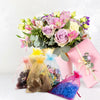 Elegant white and gold drawstring organza bags for gifts, weddings, and parties displayed with a floral arrangement