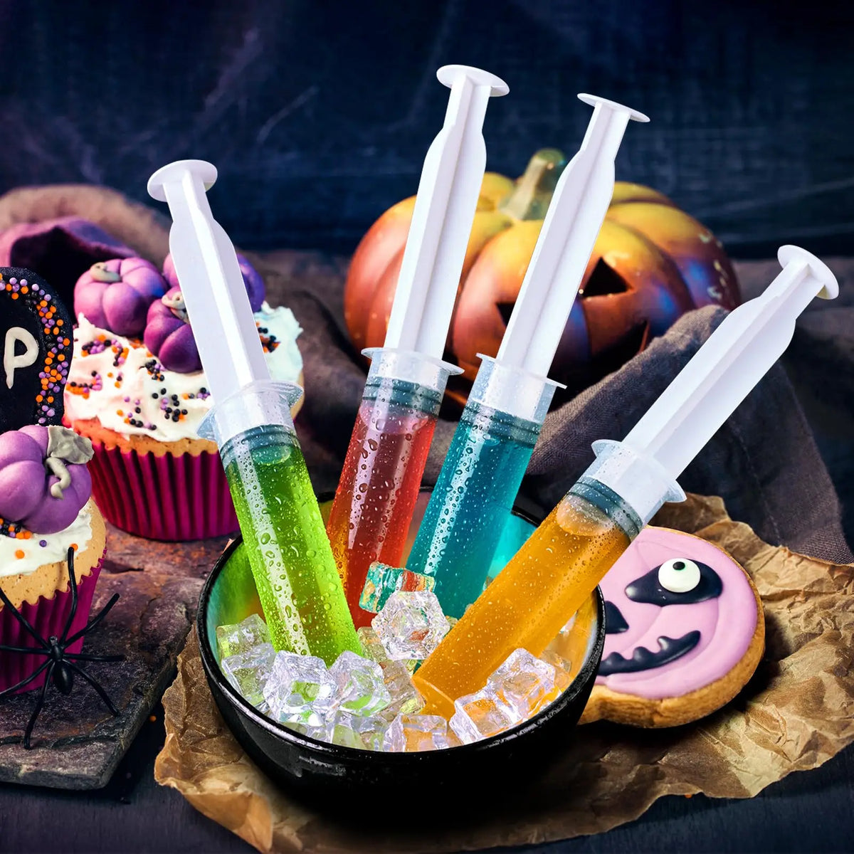 A collection of colorful party syringes with lids filled with liquids and ice cubes on brown paper.