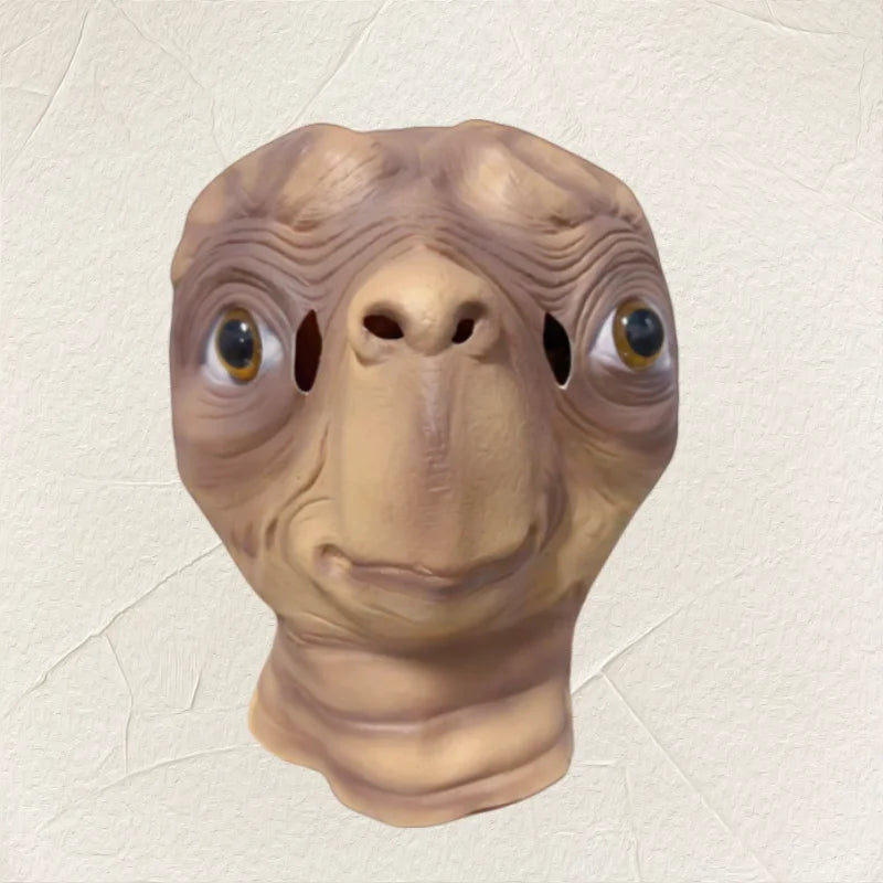 A realistic cute alien full-face latex mask with large eyes and textured skin.