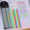 A set of sticky strips and notes on a sheet of paper, showing colorful transparent stickers and index tabs.
