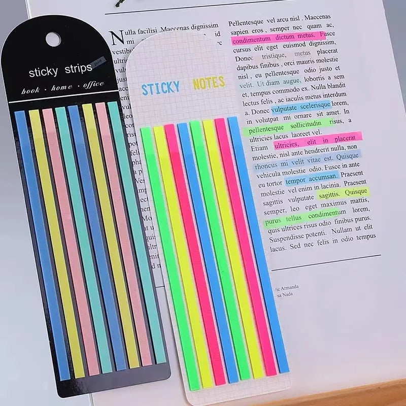 A set of sticky strips and notes on a sheet of paper, showing colorful transparent stickers and index tabs.